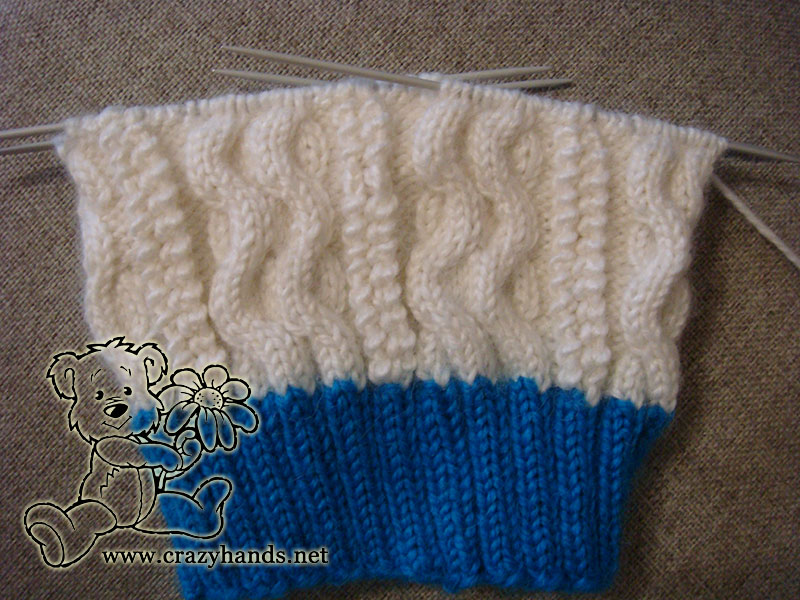 half-finished two color cable knit hat
