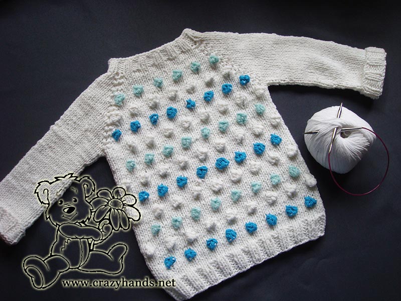 finished seamless knit bottom-up baby raglan sweater with bobbles