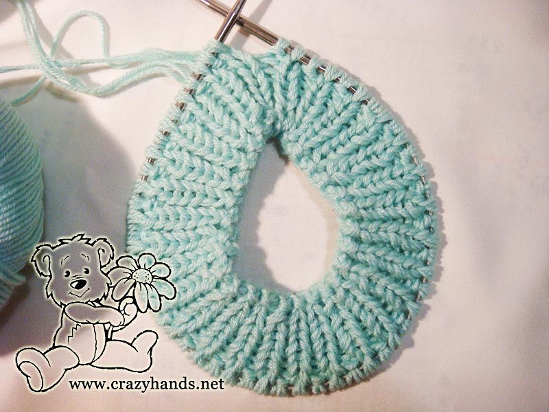 knitting the ribbing of the ocean blue baby hat