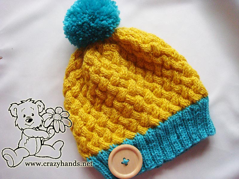 basic yellow & blue knit hat with yarn pom pom and decor button
