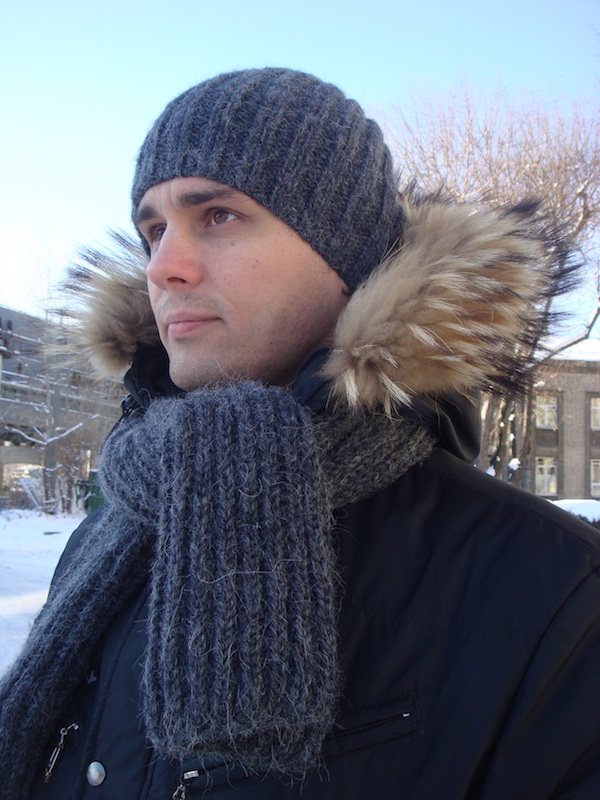 men's knit scarf and slouchy ribbed hat show on a male model - front view