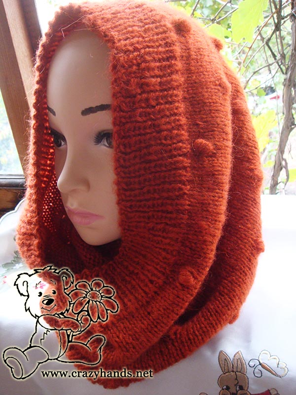 orange knit cowl with bobbles on the mannequin - hooded cowl style - left side view