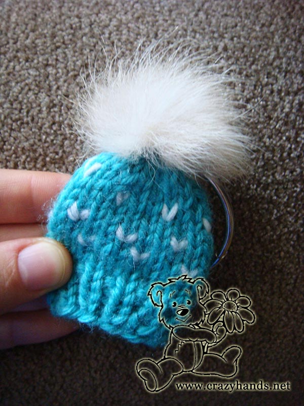 knit blue mini hat with fur pom pom