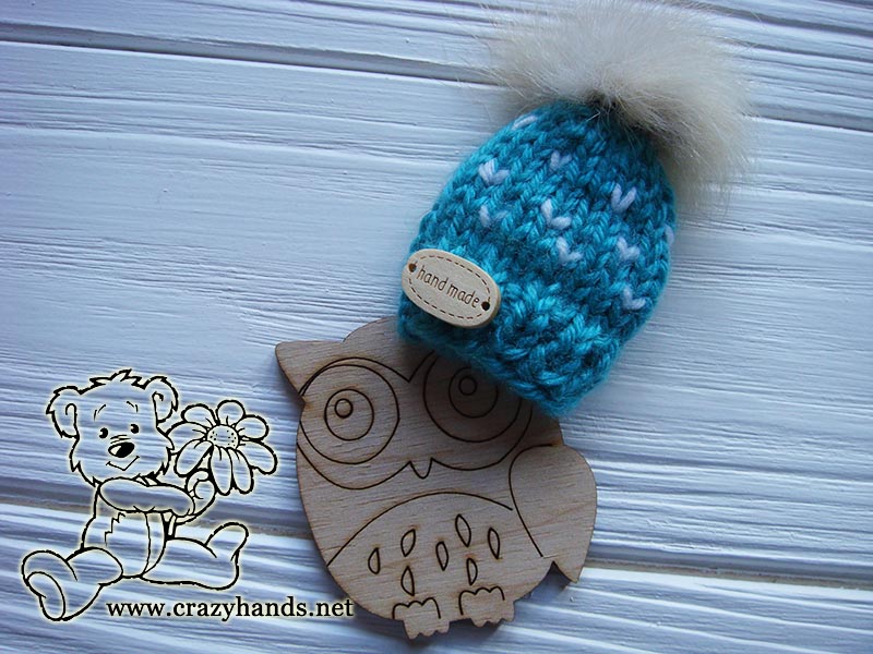 blue knit mini hat with an owl