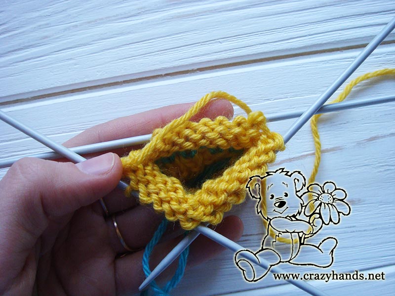 knitting the ribbing of yellow mini hat 