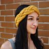 woman wears a cable knit headband