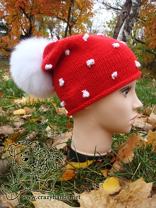 knit slouchy santa hat with bobbles and fur pom pom on the mannequin's head