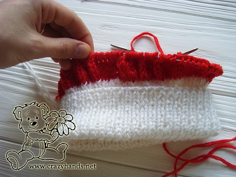 knitting body and cables of baby santa hat