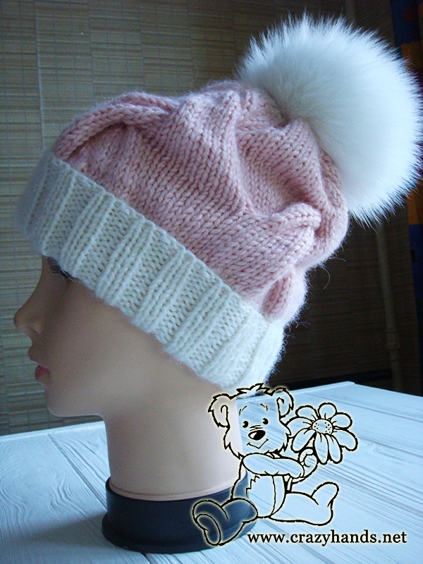 pink marshmallow cable knit hat with fur pom on the mannequin - left side view