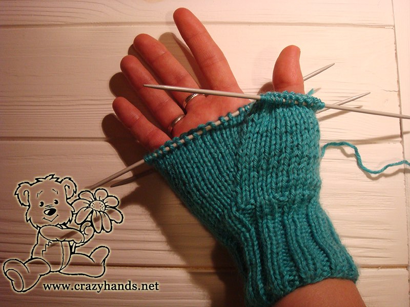 Half-finished body of the knit mitten