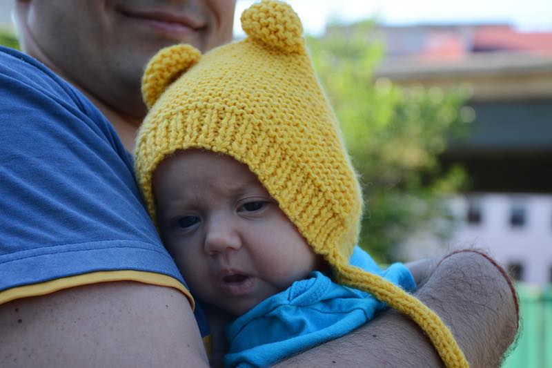 newborn baby wears teddy bear knit bonnet