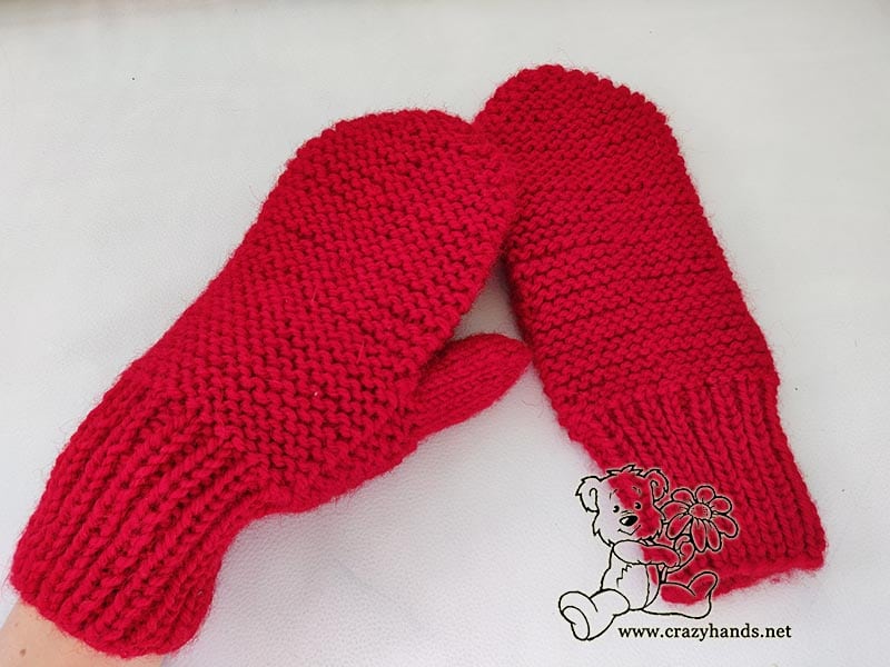 a pair of cute winter mittens knitted using garter stitch