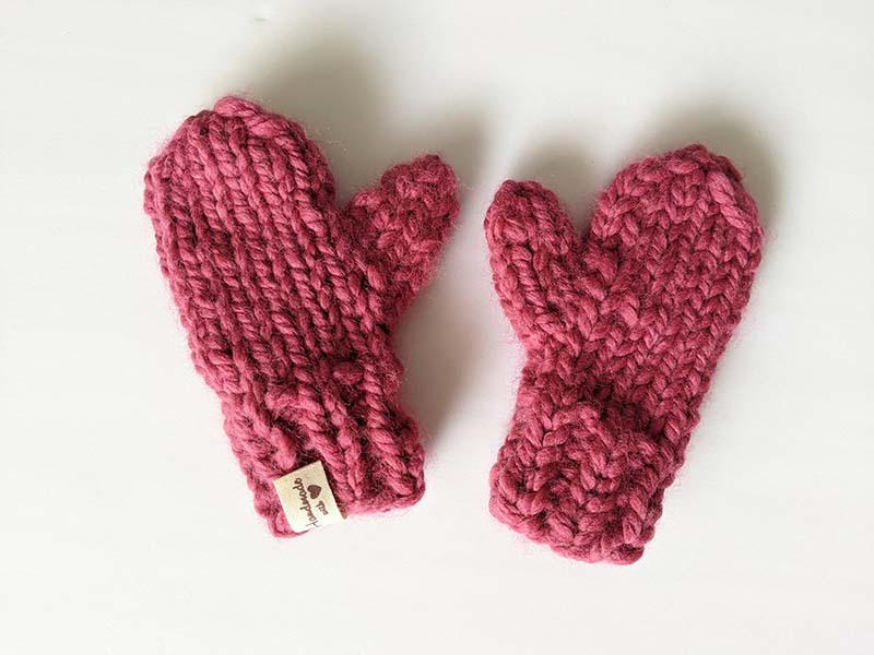 child-size mittens knitted with bulky dark red yarn