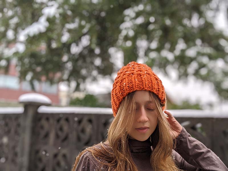 woman model wears a basket weave knit hat