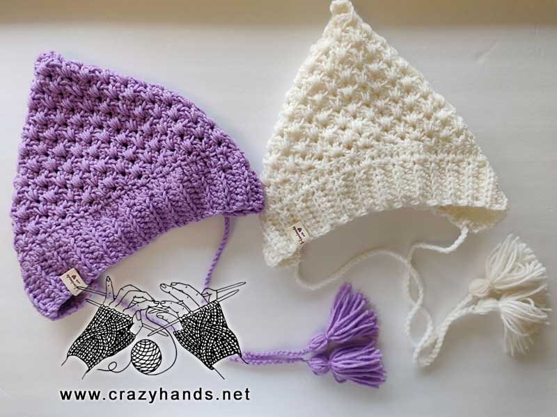 Two crochet pixie hats for toddler babies (2 years old) - violet pixie hat on the left and white pixie hat on the right