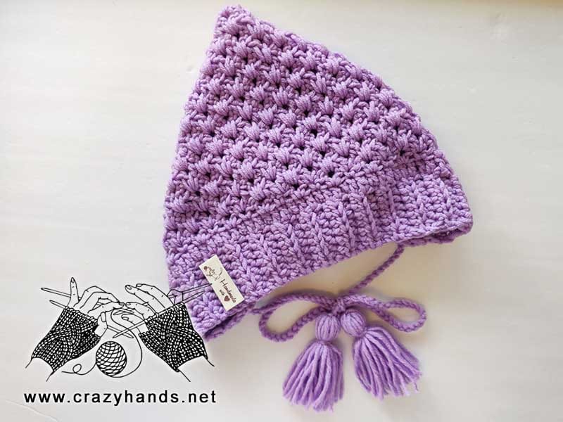 lace crochet pixie bonnet for babies with ties and tassels made with violet yarn