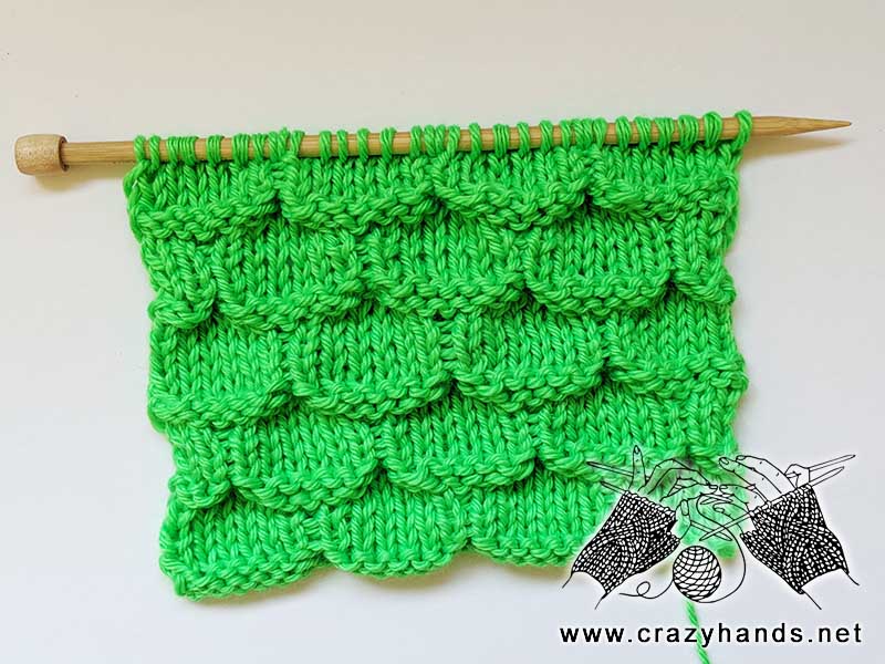 knit mermaid stitch pattern sample made with bright green yarn