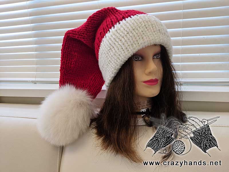 knit santa hat with fur pom and double brim on the mannequin