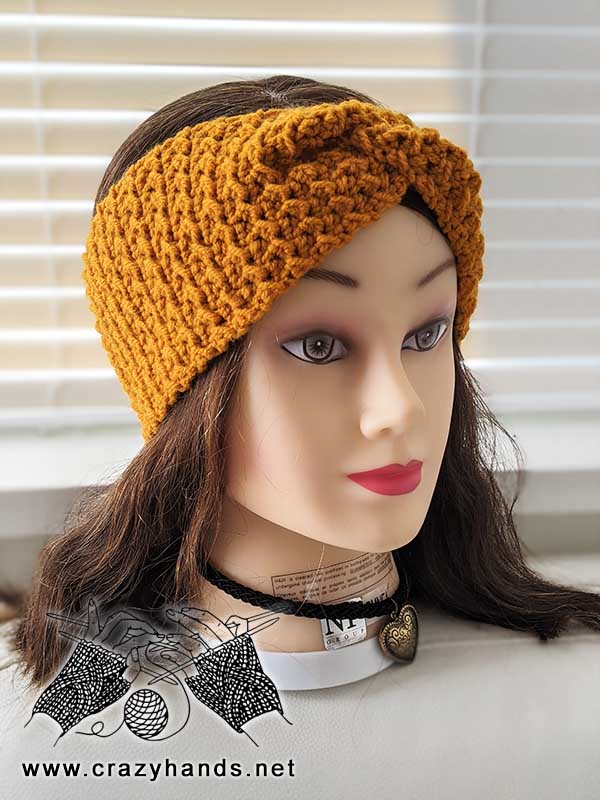 phoenix crochet ear warmer on mannequin head - front view