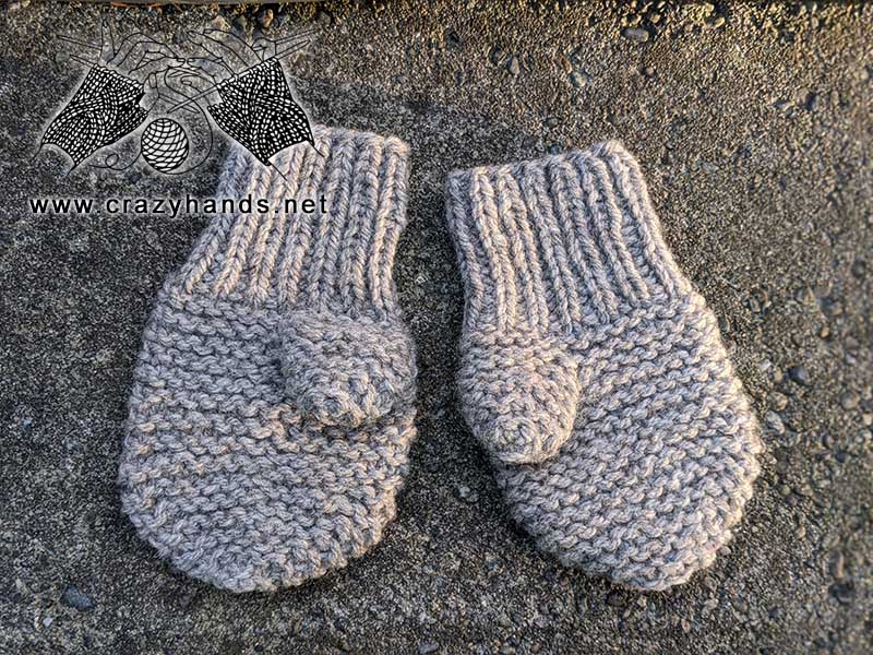 two toddler-size knit mittens made using garter stitch