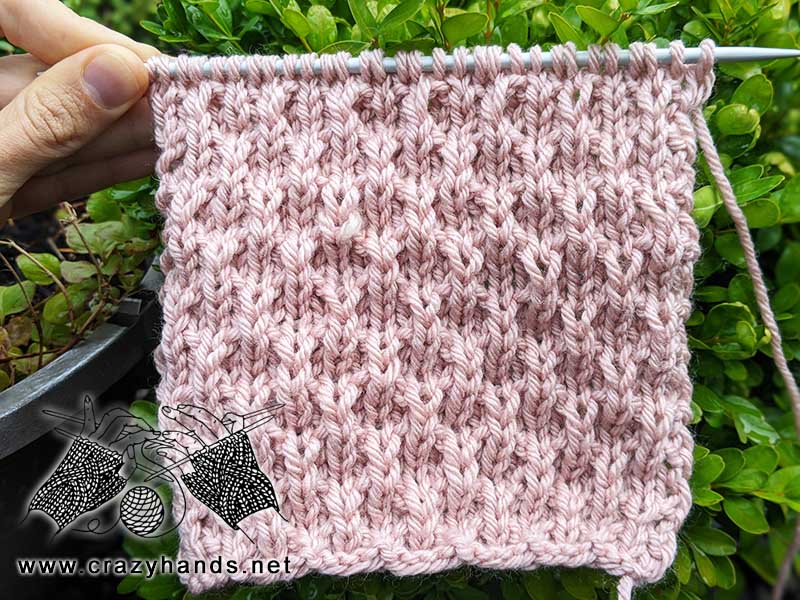 A unique knit stitch for blankets, scarfs, and sweaters. Sample stitch pattern is made with pink pastel yarn