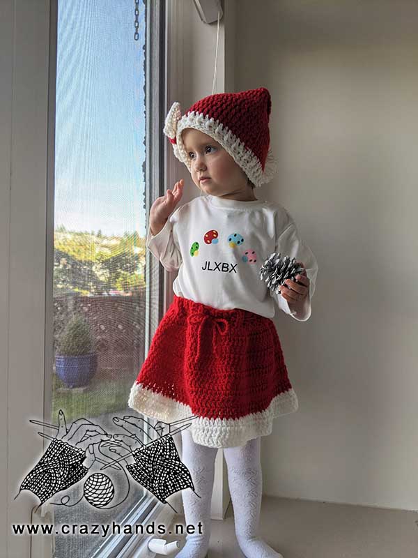 baby girl wears santa hat and skirt set