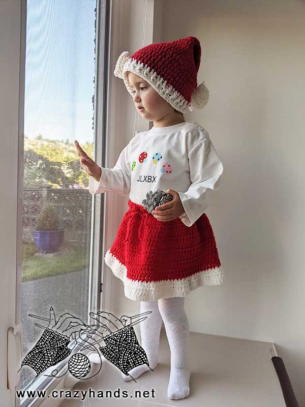 toddler girl wears crochet santa skirt and hat