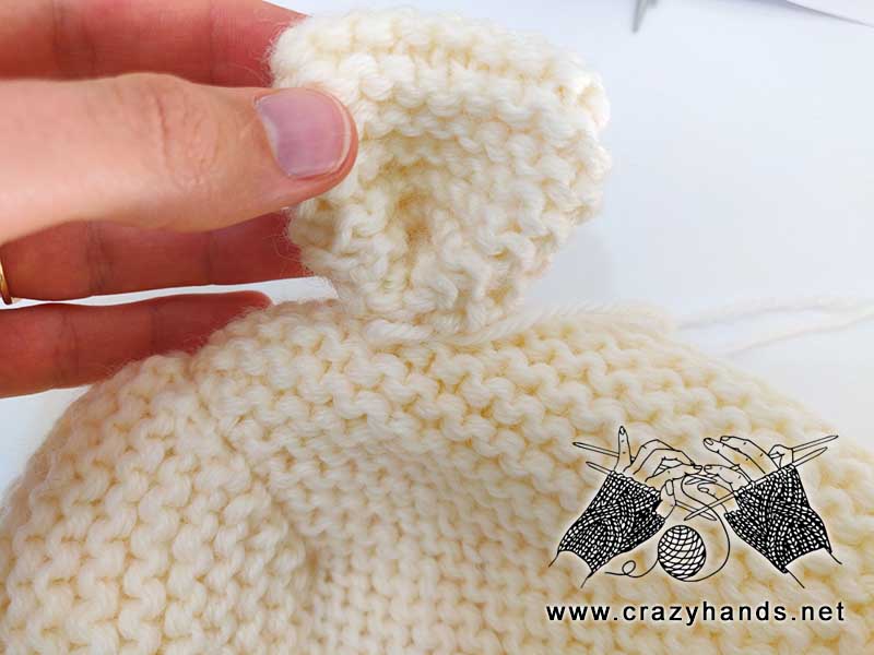 placing, sewing and shaping teddy bear's ear to the knit toddler hat