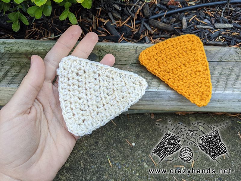 two crochet equilateral triangles - gold and white colored