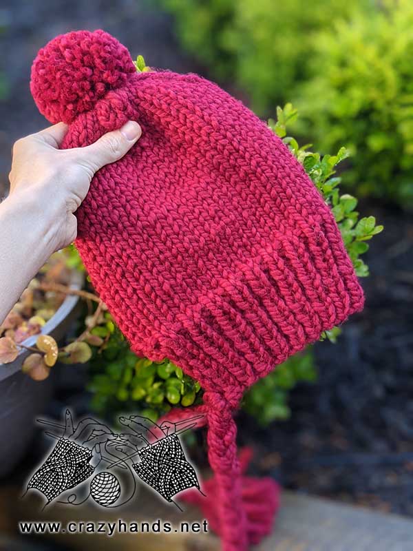 knit red riding hood hat with ties and yarn pom - side view