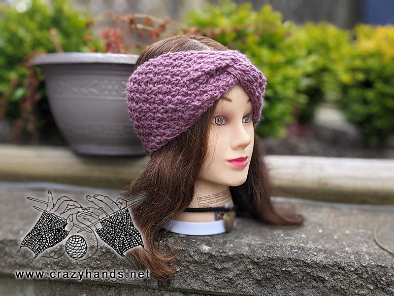 dark violet mulberry knit ear warmer on the mannequin's head