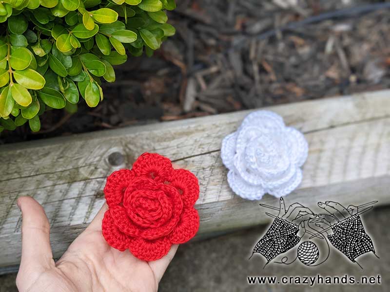 two crochet damask roses - one red and one white