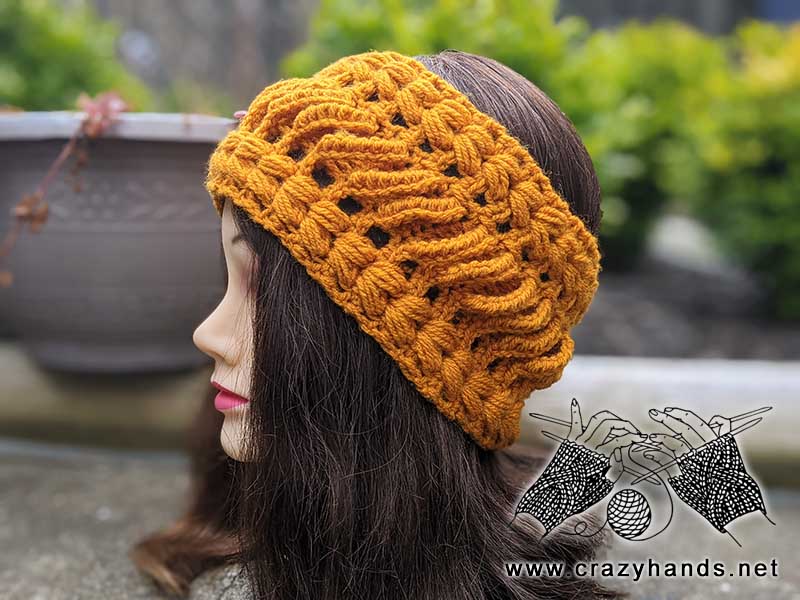 goldenberry crochet lace ear warmer on the mannequin's head - side view