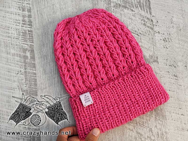 pink knit ribbed hat on circular needles
