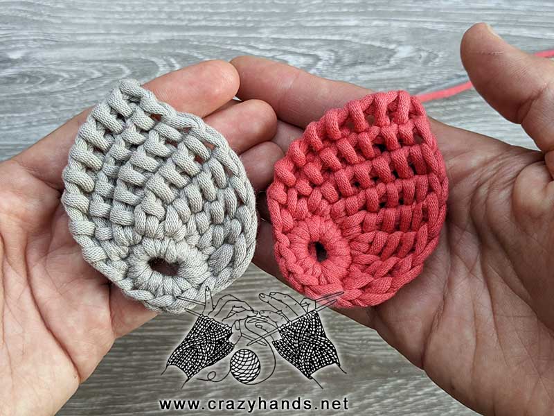 two beautiful crochet tunisian leaves - one gray and one red held next to each other
