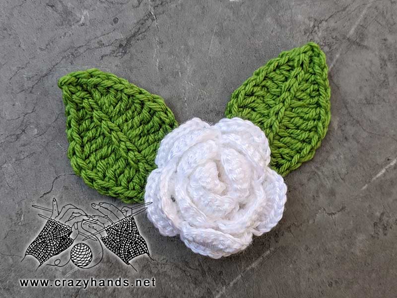 two crochet leaves and crochet white rose flower