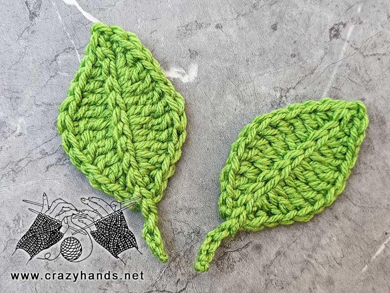 two green crochet rhomboid leaves laying next to each other