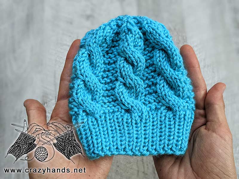 cute blue cable knit hat for a newborn baby