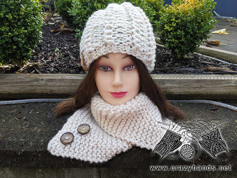 front side view of the crème de la crème knit hat and rectangular knit scarf on the mannequin