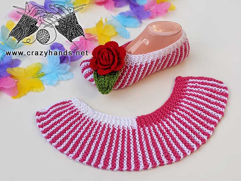 flat knit slipper socks - one sock is assembled with crochet rose and crochet leaf decor and the other sock is flat