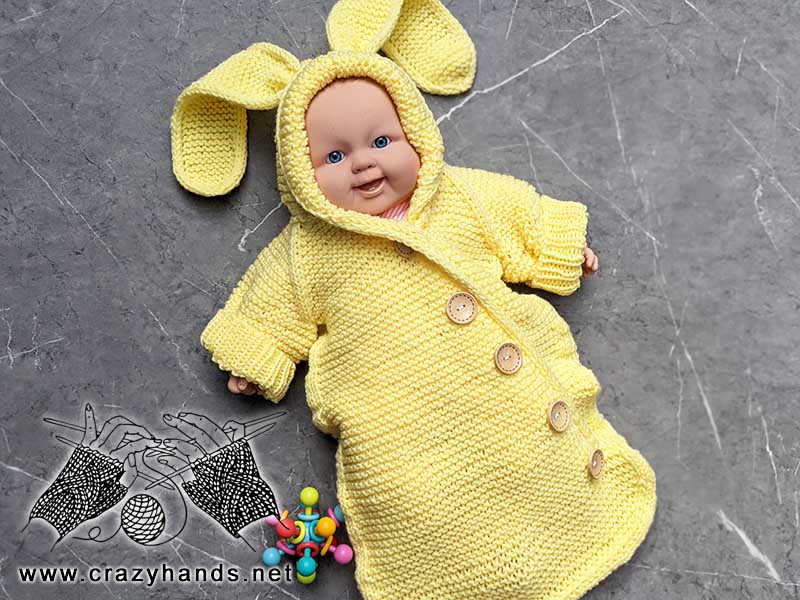 knit baby sleep wrap with bunny ears for a newborn baby