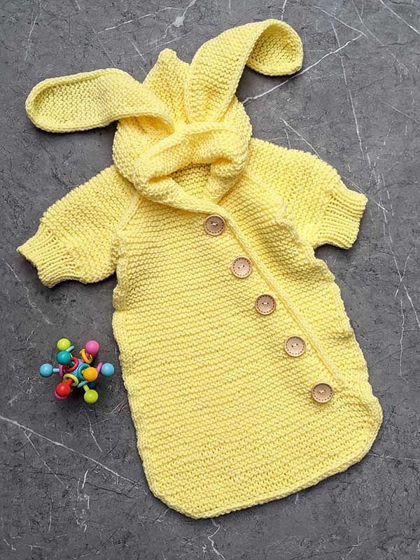 knit sleep sack with bunny ears for a newborn baby
