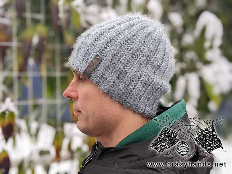 classic crochet beanie made with gray yarn on a male model