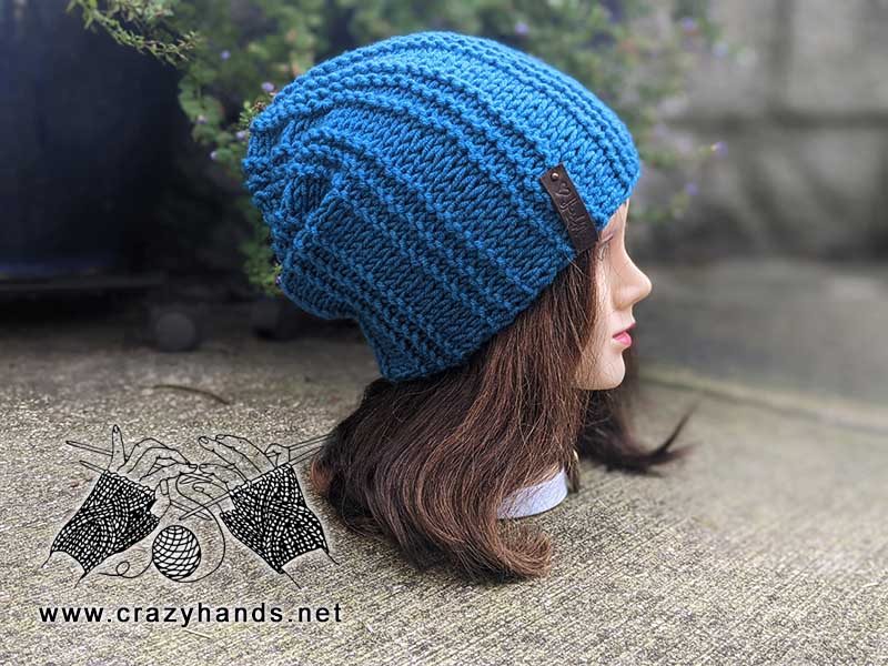 side shot of a slouchy knit hat on the mannequin