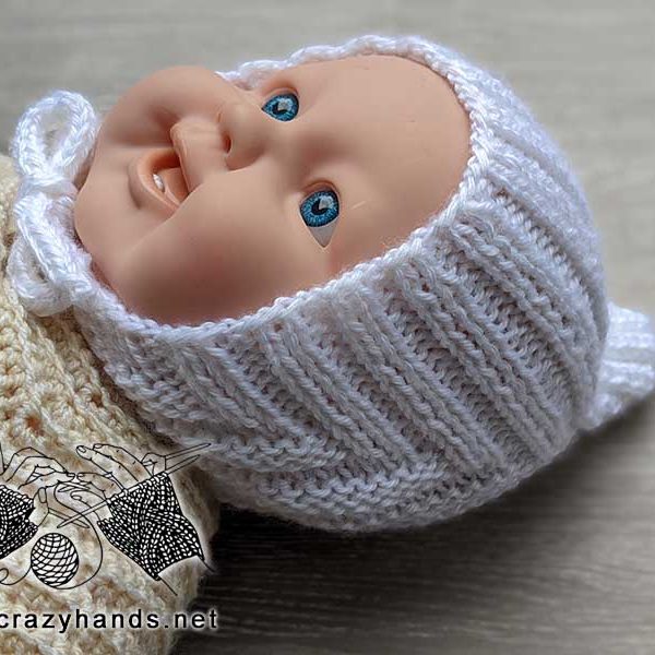 knit newborn baby pixie hat shot on the doll - side view