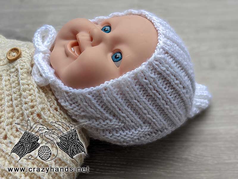 knit newborn baby pixie hat shot on the doll - side view