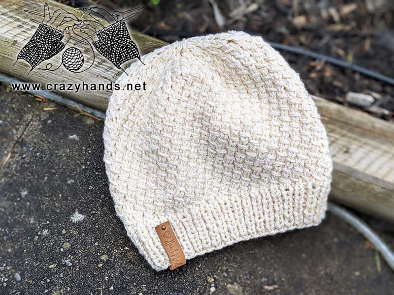 flat knit hat pattern made with white yarn on two needles