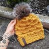 yellow bulky knit hat with fur pom pom