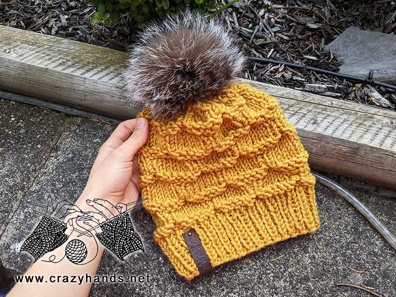 yellow bulky knit hat with fur pom pom