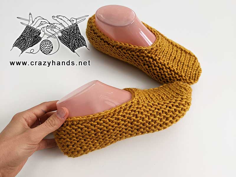two mustard knit flat slipper socks close up shot